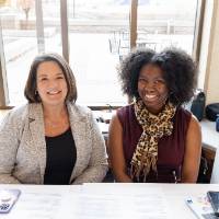 Two individual smiling for a photo
